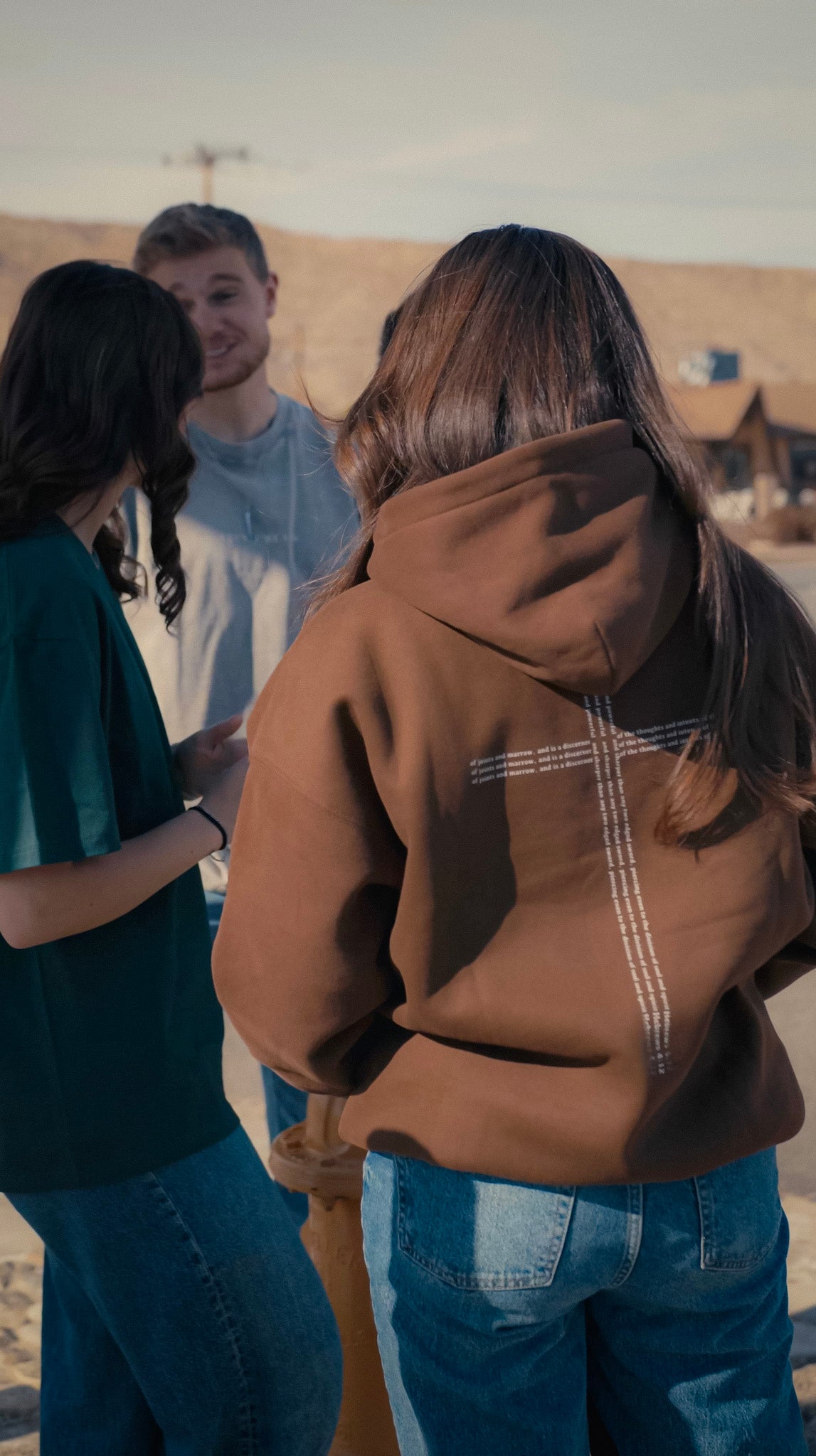Christian clothing brown Hoodie with cross back view with model