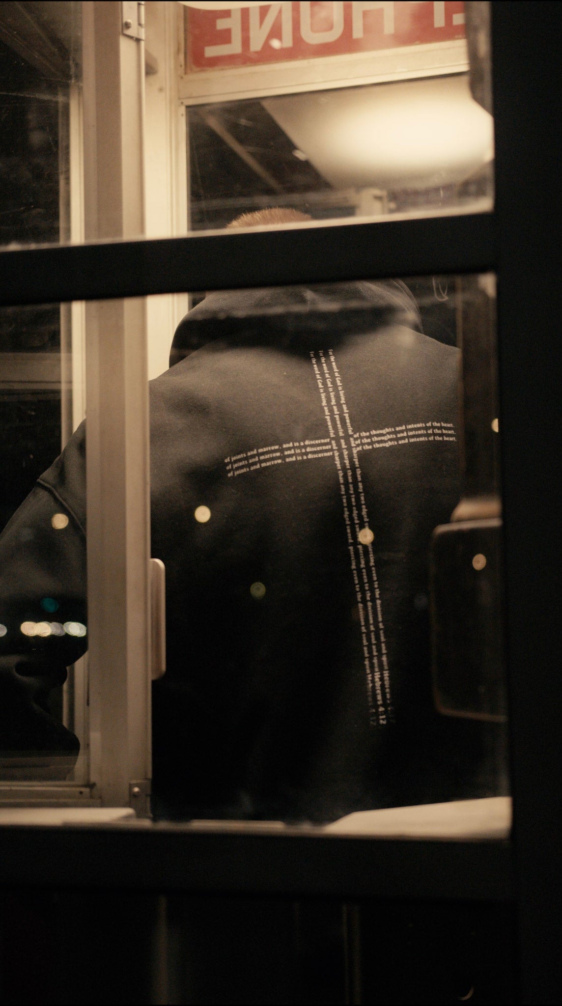 Christian clothing black Hoodie with cross back view with model